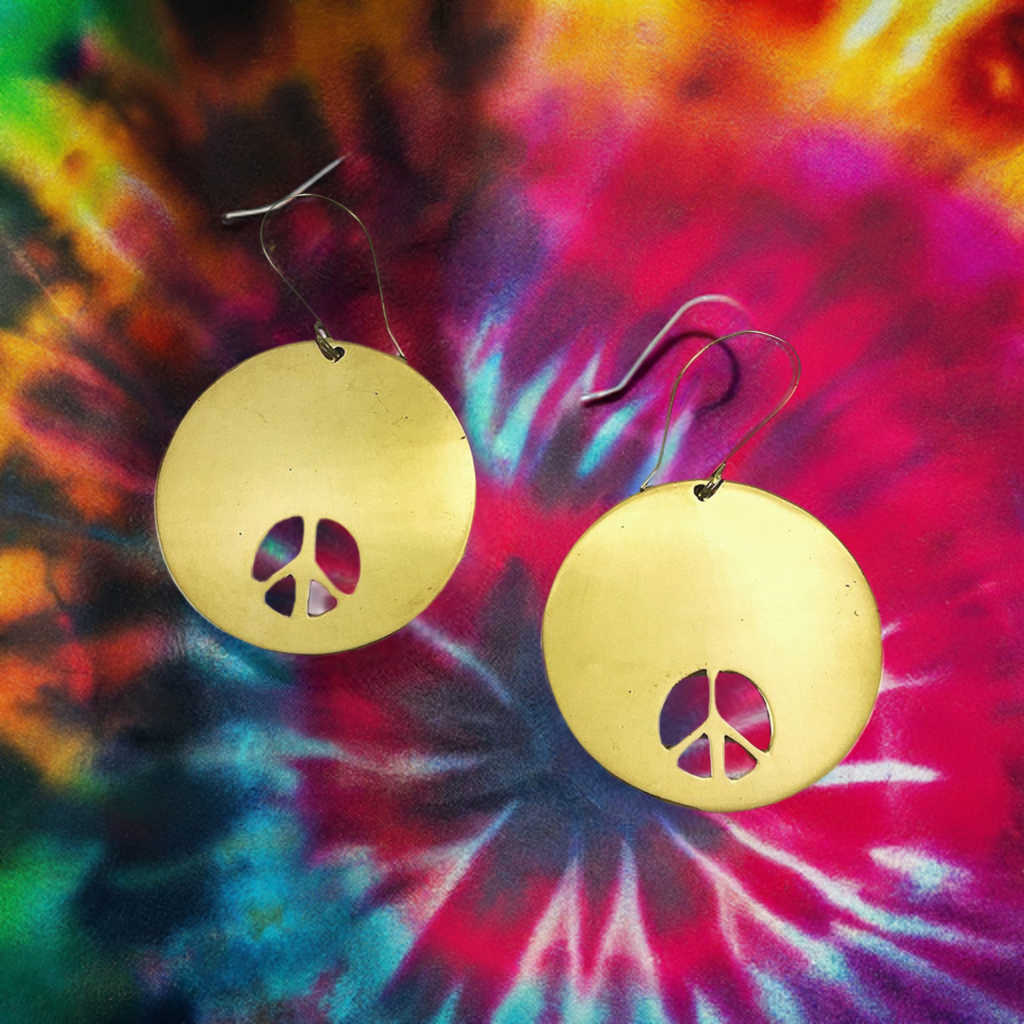 Peace sign earrings made of recycled bombshells.
